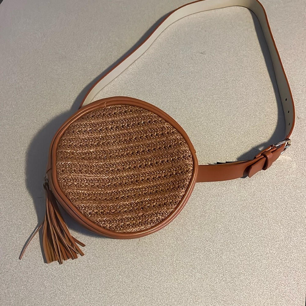 Tan circular leather bag with tassel